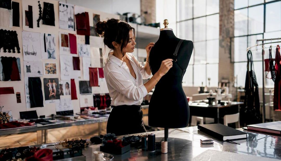 Lingerie designer adjusting bra straps on mannequin